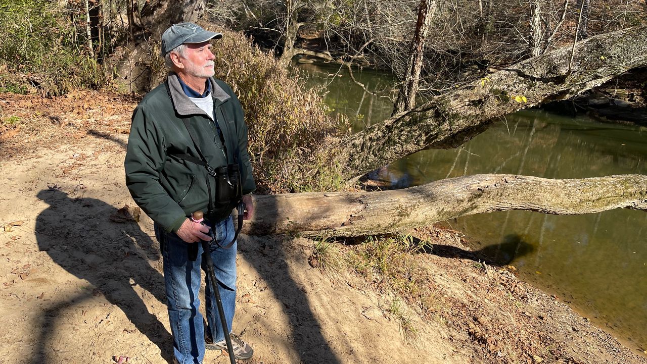 John Connors beside a stream