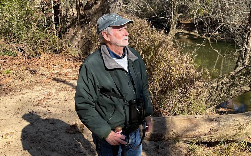 John Connors beside a stream